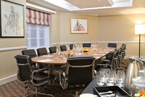 a conference room with a long table and chairs at St. Ermin's Hotel, Autograph Collection in London