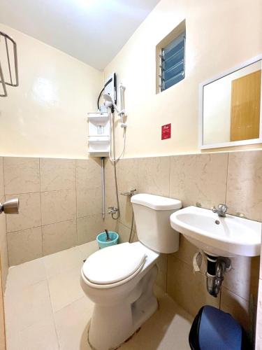 a bathroom with a toilet and a sink at MC2 Homestay Butuan in Butuan