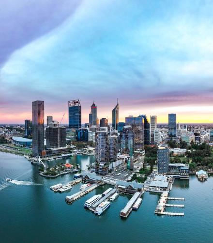 a city skyline with boats docked in the water at Affotable Relocation FIFO Long Term Queen Bedroom Near City Fremantle Sawn River in Perth