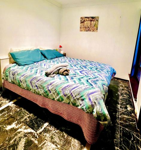 a bedroom with a bed with a colorful comforter at Affotable Relocation FIFO Long Term Queen Bedroom Near City Fremantle Sawn River in Perth