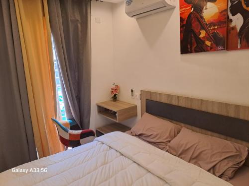 מיטה או מיטות בחדר ב-New Residence Malayika