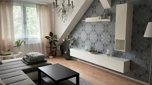 a living room with a couch and a table at Well-being oasis centrally & fully equipped in Mettmann