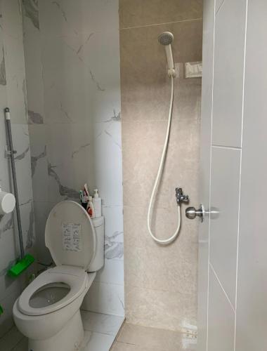 a bathroom with a toilet and a shower at entire house for you in Cikeas