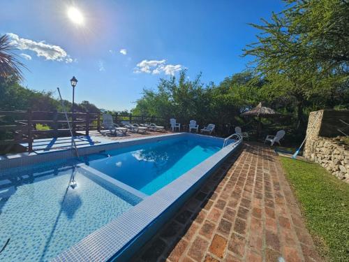 una piscina in un cortile con sedie di Cabañas Toay Merlo San Luis a Merlo