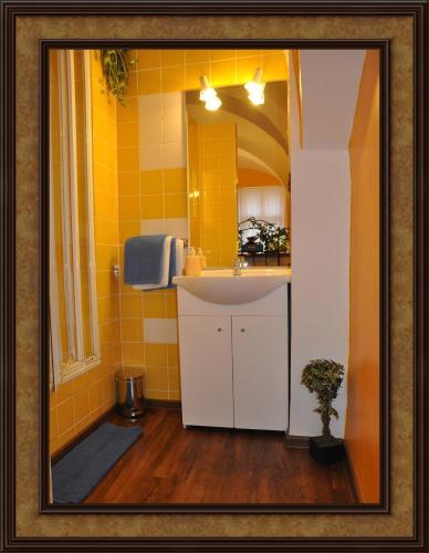 a bathroom with a sink and a mirror at Centrum Tiffany Pension in Domažlice