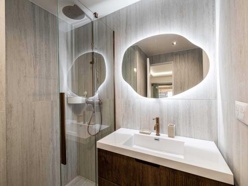 une salle de bain avec un lavabo et un miroir dans l'établissement Elegant Apt with balcony 1BD 4P - Croisette Cannes, à Cannes