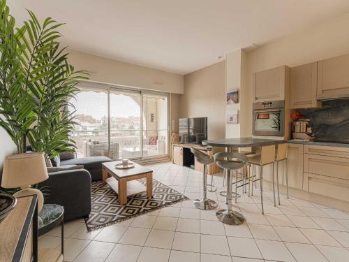 une cuisine et un salon avec un canapé et une table dans l'établissement Modern Apartment with Terrace Trouville, à Trouville-sur-Mer