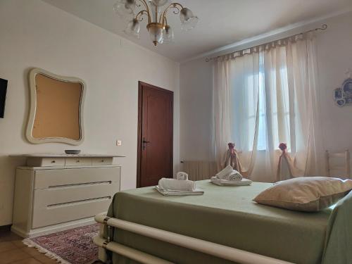 a bedroom with a bed with a mirror and a dresser at Holiday Home in Camaiore near Sandy Beaches in Camaiore