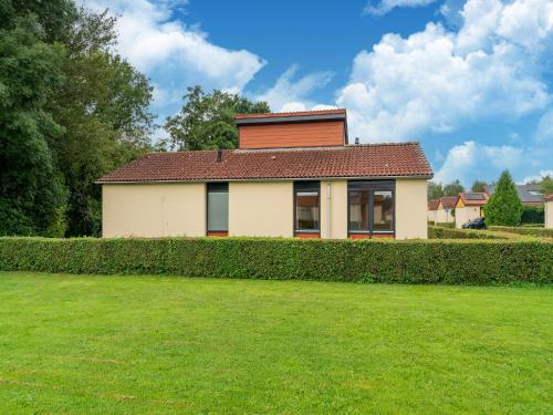 a house with a hedge in front of a yard at Holiday Home in Zevenhuizen near Rottemeren in Zevenhuizen