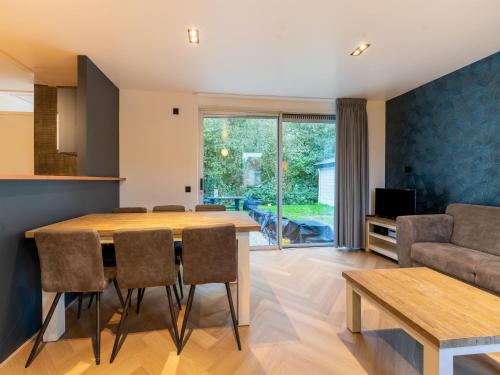 a dining room and living room with a table and chairs at Holiday Home in Zevenhuizen near Rottemeren in Zevenhuizen