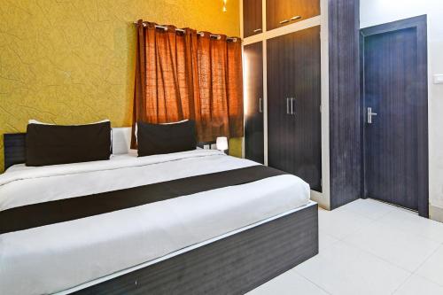 a bedroom with a large bed and a window at Hotel O Home Bm-x in Khandagiri