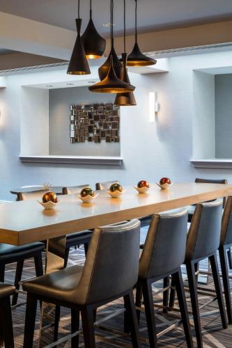 a dining room with a large wooden table and chairs at Renaissance Providence Downtown Hotel in Providence