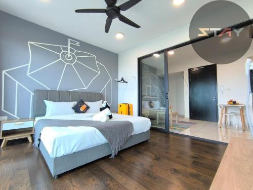 a bedroom with a large bed with a ceiling fan at Almas 2Pax Comfort Stylish 100mbps Netflix By STAY in Nusajaya