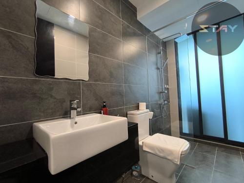 a bathroom with a white sink and a toilet at Almas 2Pax Comfort Stylish 100mbps Netflix By STAY in Nusajaya