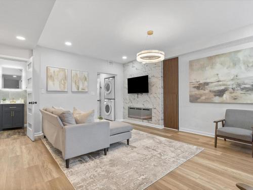 a living room with a couch and a tv at Lawrenceville Central !5 Spacious and Quiet Three Bedroom Apartment with Free Street Parking in Pittsburgh