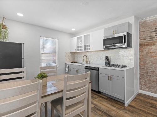 a kitchen with a table and a dining room at Lawrenceville Central !5 Spacious and Quiet Three Bedroom Apartment with Free Street Parking in Pittsburgh