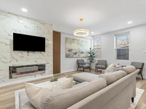 a living room with a large couch and a fireplace at Lawrenceville Central !5 Spacious and Quiet Three Bedroom Apartment with Free Street Parking in Pittsburgh