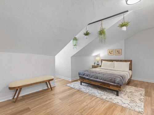 a bedroom with a bed and a bench in it at Lawrenceville Central !5 Spacious and Quiet Three Bedroom Apartment with Free Street Parking in Pittsburgh