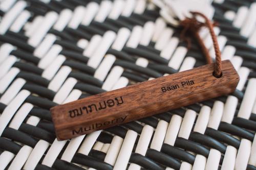 a wooden stick sitting on top of an organ at Baan Pila in Luang Prabang