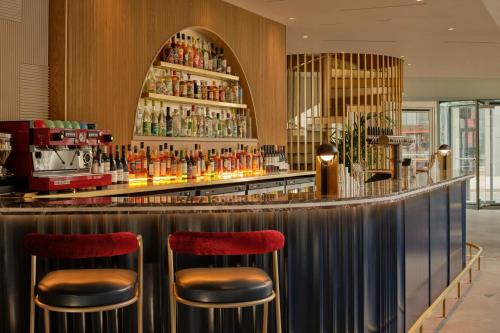a bar with red stools in a restaurant at Montcalm East, Autograph Collection in London