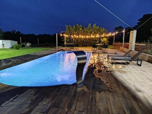 a swimming pool in a yard at night at Sitio Cantin in Piumhi