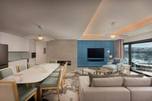a kitchen and living room with a table and a couch at The Westin Dragonara Resort, Malta in St Julian's