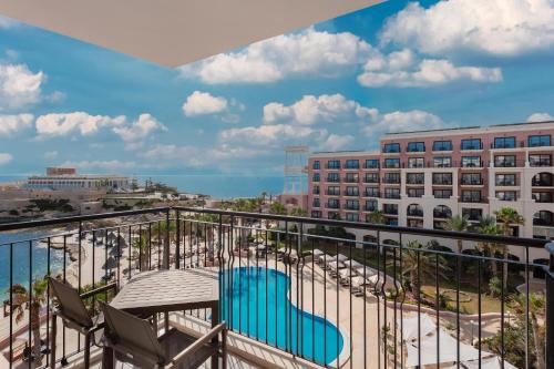 a balcony with chairs and a view of the ocean at The Westin Dragonara Resort, Malta in St Julian's