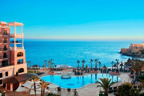 a view of a resort with a swimming pool and the ocean at The Westin Dragonara Resort, Malta in St Julian's