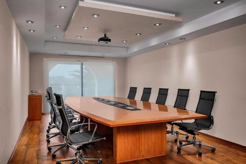 a conference room with a wooden table and chairs at The Westin Dragonara Resort, Malta in St Julian's