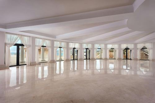 an empty room with white walls and a white floor at The Westin Dragonara Resort, Malta in St Julian's