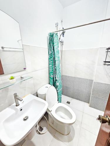 a bathroom with a toilet and a sink at Demit Apartment- 2br near airport - 2 in Puerto Princesa City