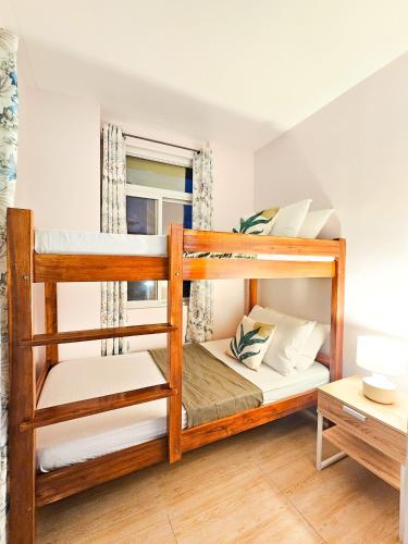 a bedroom with bunk beds in a house at Demit Apartment- 2br near airport - 2 in Puerto Princesa City