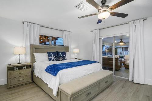a bedroom with a bed and a ceiling fan at The Waterfront Fishing Retreat in Cape Coral