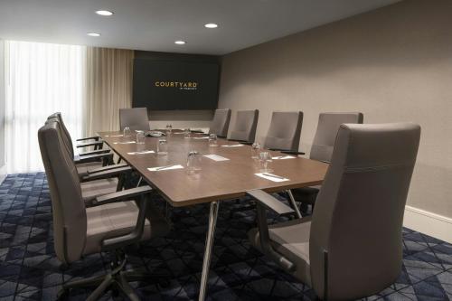 a conference room with a long table and chairs at Courtyard by Marriott Long Beach Downtown in Long Beach