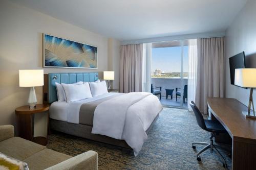 a hotel room with a bed and a desk and a computer at The Westin Sarasota in Sarasota