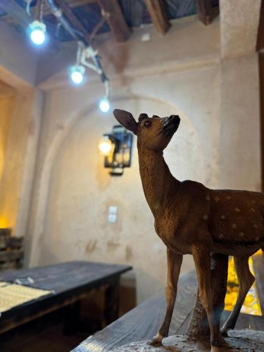 a wooden statue of a deer sitting on a table at Amerdoul in Icht