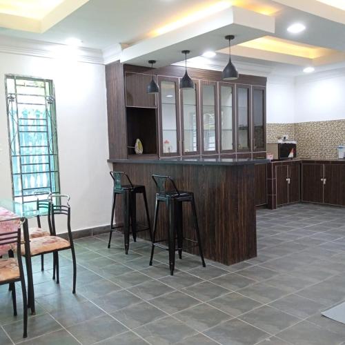 a room with a bar with chairs and tables at Putra Heights Subang Jaya Paradise Property No 1 in Subang Jaya