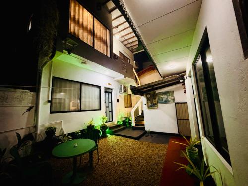 a hallway of a building with a table and plants at Shehan Villa in Beruwala