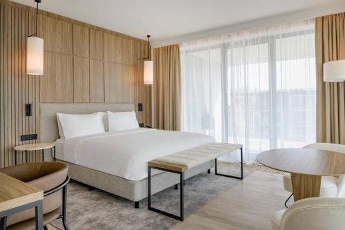 a hotel room with a bed and a table at AC Hotel by Marriott Krakow in Kraków