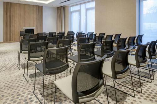 a room with rows of chairs in a conference room at AC Hotel by Marriott Krakow in Kraków
