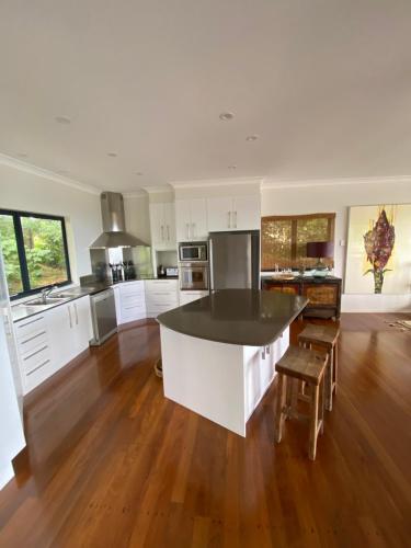 a large kitchen with white cabinets and a black counter top at Balmoral 575 in Montville