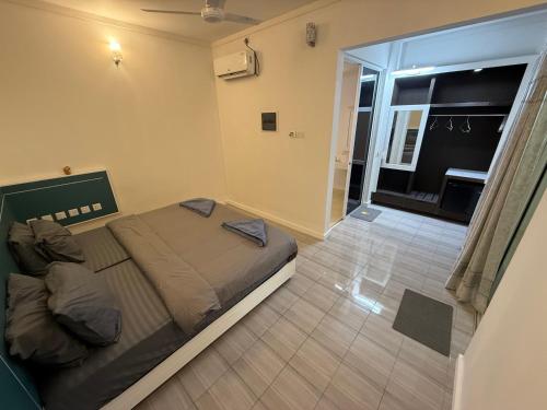 a bedroom with a large bed and a balcony at Paradise by Rashuthere Maldives in Rasdu