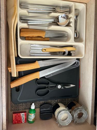a drawer filled with cooking utensils and other kitchen items at La Casita Aeropuerto Guadalajara in San José del Castillo