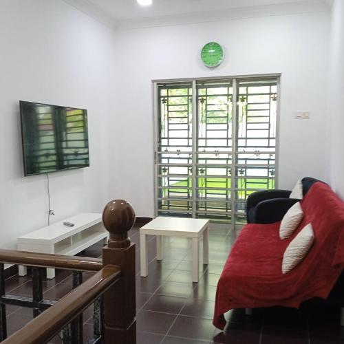 a living room with a couch and a table at Putra Heights Subang Jaya Paradise Property No 1 in Subang Jaya
