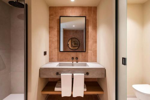 a bathroom with a sink and a mirror at Mangia's Brucoli, Sicily, Autograph Collection in Brucoli