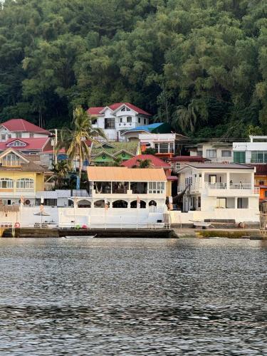 a group of houses on the shore of a body of water at Dreamscape Villa in Batangas City