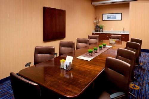 a conference room with a large wooden table and chairs at Courtyard by Marriott Cypress Anaheim / Orange County in Cypress