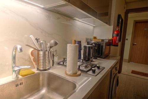 a kitchen counter top with a sink and a counter top at Stylish Studio Retreat in Dubai