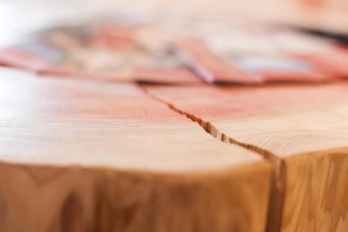 einem Holztisch mit einem Stück Holz darauf in der Unterkunft Kuckucksnest Lenzkirch in Lenzkirch