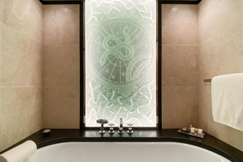 a bath tub in a bathroom with a window at Bvlgari Hotel Paris in Paris